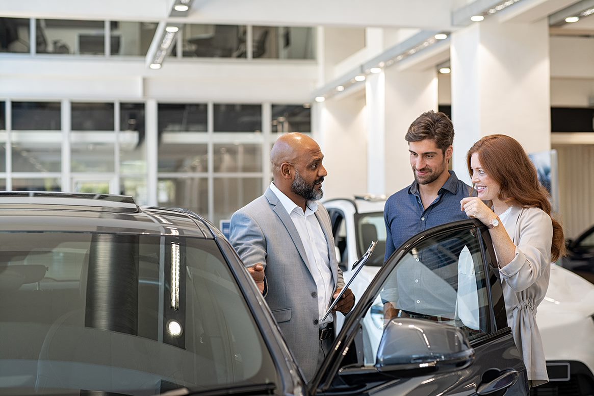 car dealer with couple